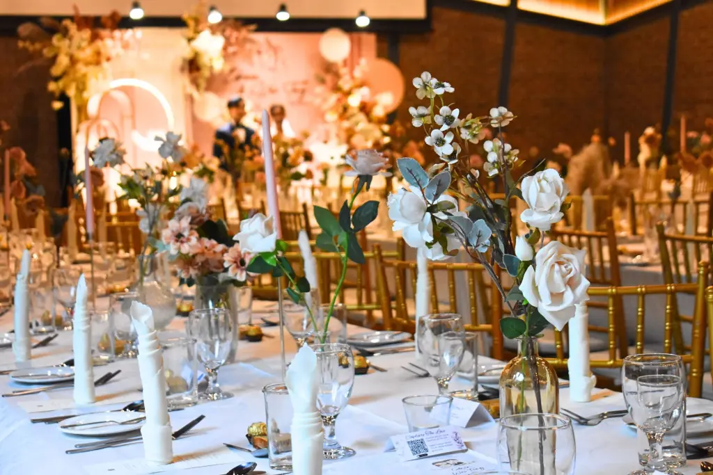 Elegant indoor wedding banquet setup with gold chairs and white floral centerpieces in Kuala Lumpur by Teaffani Catering